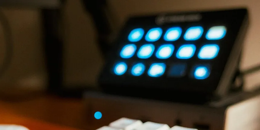A Stream Deck on a desk in a dark room, its fifteen keys lit blue